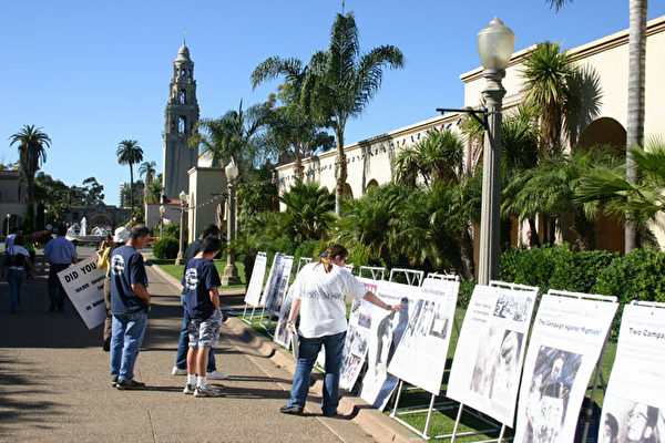 集会同时举办的中共暴政史图片展吸引了大量游人驻足观看。