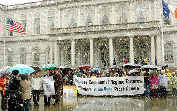 清明飞雪，千古奇冤。2006年4月5日纽约法轮功学员市府门前集会，抗议中共设集中营虐杀中国同胞。（新纪元资料室）