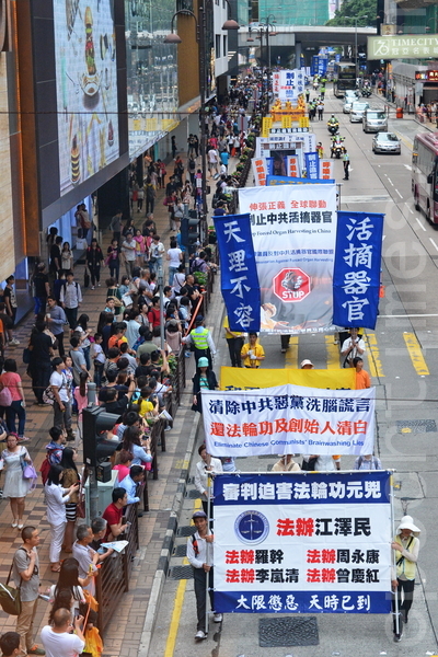 香港法輪功學員20日在長沙灣舉行「四二五」15周年反迫害集會遊行，途中經過市中心旺角、尖沙咀，吸引了大批港民和大陸遊客觀看。（宋祥龍／大紀元）