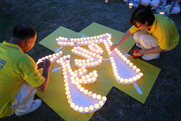 2014年7月13日，台灣新竹市，法輪功學員舉辦燭光悼念活動，希望藉此喚起民眾的正義良知，共同譴責中共暴行，制止迫害。（林仕傑/大紀元）