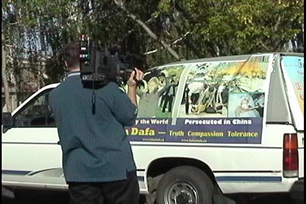 图：萨省Yorkton电视台记者在拍摄，采访横加紧急救援万里行的法轮功学员张先生一行。 （大纪元图片）