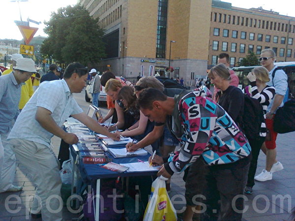 7月18日，芬兰首都中心火车站广场上，当地民众纷纷签名反对中共活摘法轮功学员器官暴行。（李乐/大纪元）