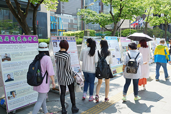 2015年5月10日，韓國慶祝第16屆「5.13世界法輪大法日」及法輪大法洪傳23週年。過往遊客關注。（金國煥/大紀元） 