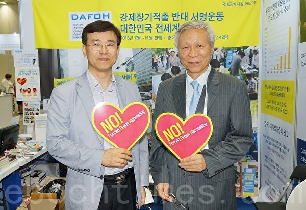 2015世界護士大會6月19～23日在韓國首爾國際會展中心（Ceox）舉行。與會者手舉反對強摘器官的標籤攝影留念。（金國煥/大紀元）