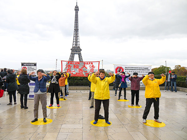 法輪功學員在巴黎艾菲爾鐵塔下的人權廣場上演示功法。（明慧網）