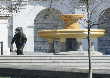 A member of the bomb squad responds to reports of a shooting at the US Capitol in Washington, DC, April 11, 2015. Shots were fired near the steps of the US Capitol Saturday leading to a lockdown of the building, police said, adding that the threat had been "neutralized." US Capitol Police told AFP that the shooting took place on the western side of the building and that officers are investigating a suspicious package on a nearby terrace. Police did not provide details on the shooting, but said a "threat" had been "neutralized." AFP PHOTO / SAUL LOEB (Photo credit should read SAUL LOEB/AFP/Getty Images)