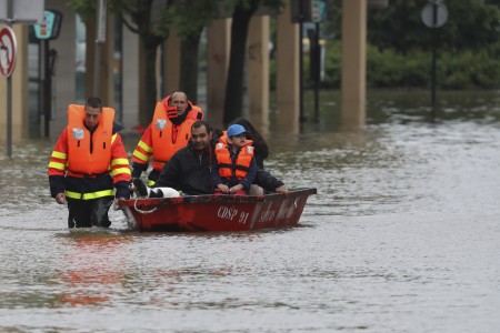 Firefighters evacuate people in a small boat in a flooded street after the Yvette river burst its banks and forced residents to be evacuated in Longjumeau, some 20kms south of Paris, on June 2, 2016. Torrential downpours have lashed parts of northern Europe in recent days, leaving four dead in Germany, breaching the banks of the Seine in Paris and flooding rural roads and villages. AFP PHOTO /KENZO TRIBOUILLARD / AFP / KENZO TRIBOUILLARD (Photo credit should read KENZO TRIBOUILLARD/AFP/Getty Images)