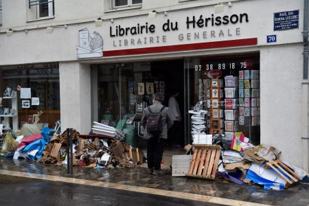Bookstore owners clear their devastated premises following floods caused by heavy rainfalls in Montargis, some 130 kilometers south of Paris, on June 2, 2016. Some towns in central France are suffering their worst floods in more than a century, with more than 5,000 people evacuated since the weekend. Forecaster Meteo France described the situation as "exceptional, worse than the floods of 1910", when even central Paris was flooded. / AFP / ALAIN JOCARD (Photo credit should read ALAIN JOCARD/AFP/Getty Images)