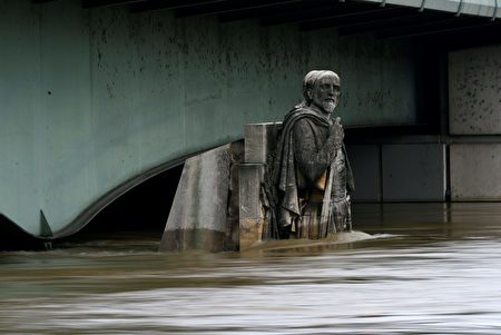 This picture taken on June 3, 2016 shows the Zouave statue of the Alma bridge flooded by the river Seine following heavy rainfalls in Paris. Paris' Louvre and Orsay museums shut on June 3 to remove art treasures from their basements as the swollen River Seine neared its highest level in three decades. At least 16 people have been killed in floods that have wrought havoc in parts of Europe after days of pounding rain, trapping people in their homes and forcing rescuers to row lifeboats down streets turned into rivers. / AFP / Bertrand GUAY (Photo credit should read BERTRAND GUAY/AFP/Getty Images)