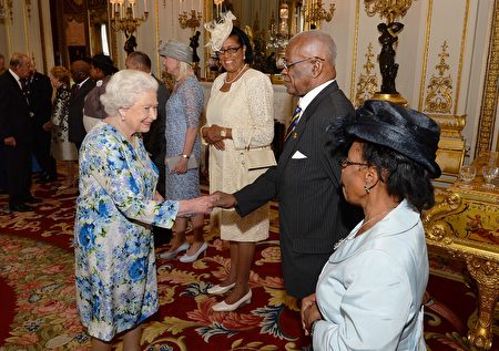 Britain's Queen Elizabeth II (L) shakes hands with Governor-General of Barbados Elliott Belgrave (2R) during a reception ahead of the Governor General's lunch in honour of the Queen's 90th birthday at Buckingham Palace in London on June 10, 2016. Britain started a weekend of events to celebrate the Queen's 90th birthday. The Queen and the Duke of Edinburgh along with other members of the royal family will attend a national service of thanksgiving at St Paul's Cathedral on June 10, which is also the Duke of Edinburgh's 95th birthday. / AFP / POOL / John Stillwell (Photo credit should read JOHN STILLWELL/AFP/Getty Images)