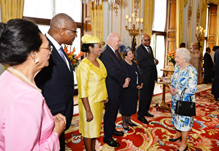 Britain's Queen Elizabeth II (R) meets guests during a reception ahead of the Governor General's lunch in honour of the Queen's 90th birthday at Buckingham Palace in London on June 10, 2016. Britain started a weekend of events to celebrate the Queen's 90th birthday. The Queen and the Duke of Edinburgh along with other members of the royal family will attend a national service of thanksgiving at St Paul's Cathedral on June 10, which is also the Duke of Edinburgh's 95th birthday. / AFP / POOL / John Stillwell (Photo credit should read JOHN STILLWELL/AFP/Getty Images)