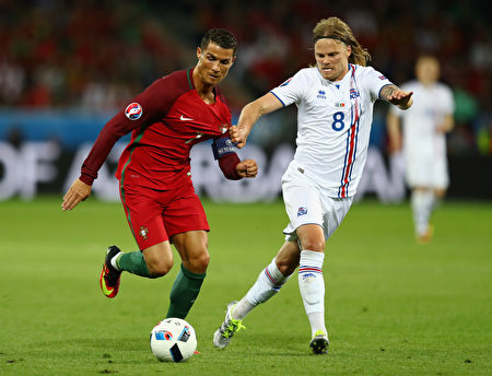 SAINT-ETIENNE, FRANCE - JUNE 14:  Cristiano Ronaldo of Portugal battles with Birkir Bjarnason of Iceland during the UEFA EURO 2016 Group F match between Portugal and Iceland at Stade Geoffroy-Guichard on June 14, 2016 in Saint-Etienne, France  (Photo by Julian Finney/Getty Images)