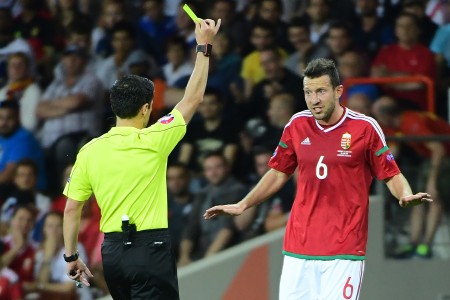 Hungary's midfielder Akos Elek (R) reacts as he receives a yellow card from Serbian referee Milorad Mazic during the Euro 2016 round of 16 football match between Hungary and Belgium at the Stadium Municipal in Toulouse on June 26, 2016. / AFP / EMMANUEL DUNAND (Photo credit should read EMMANUEL DUNAND/AFP/Getty Images)
