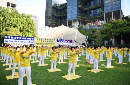 新加坡部分法輪功學員2016年7月11日下午在芳林公園集會，舉行紀念720法輪功反迫害17周年的活動。圖為法輪功學員在展示功法。（Tony/大紀元）