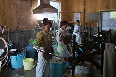 MIYOSHI, JAPAN - APRIL 22: Women work in a small tofu factory, one of the few remaining businesses in her village, on April 22, 2016 in Ochiai, Miyoshi, Japan. Many rural areas of Japan have become heavily depopulated as younger people leave for cities and larger towns in search of work and better prospects. Many of the people who remain are pensioners who, according to Japan's Statistic Bureau, make up 26.8 percent of the population compared to the 8.2 percent average for the rest of the world. (Photo by Carl Court/Getty Images)