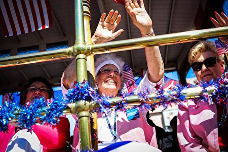 Women on a float wave to the crowds while riding through the 4th of July Parade, in Alameda, California on Monday, July 4, 2016. / AFP / GABRIELLE LURIE (Photo credit should read GABRIELLE LURIE/AFP/Getty Images)