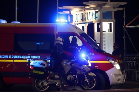 Police officers and firefighters arrive near the site of an attack on July 14, 2016, after a van ploughed into a crowd leaving a fireworks display in the French Riviera town of Nice. Up to 30 people are feared dead and over 100 others were injured after a van drove into a crowd watching Bastille Day fireworks in the French resort of Nice on July 14, a local official told French television, describing it as a "major criminal attack". / AFP / VALERY HACHE (Photo credit should read VALERY HACHE/AFP/Getty Images)