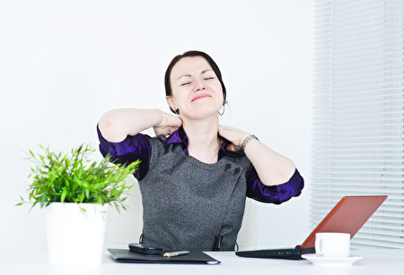 Business woman with pain in her neck