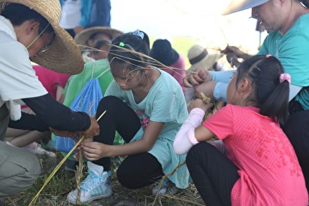 梦想新农水稻班学员带着小孩共同体验手捻制作草绳。（曾汉东／大纪元）