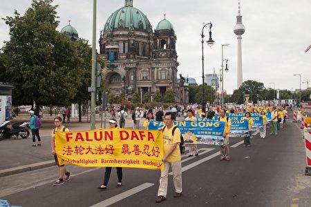  7月30日，法輪功學員在柏林舉行的大型遊行活動，圖為法輪功學員展現的各種橫幅。（Jason Wang／大紀元）