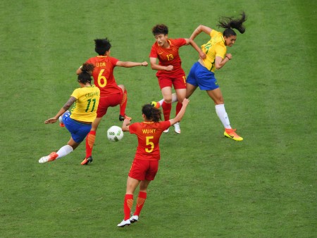 RIO DE JANEIRO, BRAZIL - AUGUST 03: Cristiane (11) and Beatriz of Brazil (16) battle with Dongna Li (6), Haiyan Wu (5) and Fengyue Pang of China (13) during the Women's Group E first round match between Brazil and China PR during the Rio 2016 Olympic Games at the Olympic Stadium on August 3, 2016 in Rio de Janeiro, Brazil. (Photo by Shaun Botterill/Getty Images)