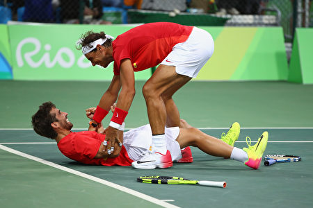  纳达尔（上）与老友洛佩兹携手，夺得里约奥运网球男子双打金牌，两人在场上兴奋庆祝胜利。 (Clive Brunskill/Getty Images)