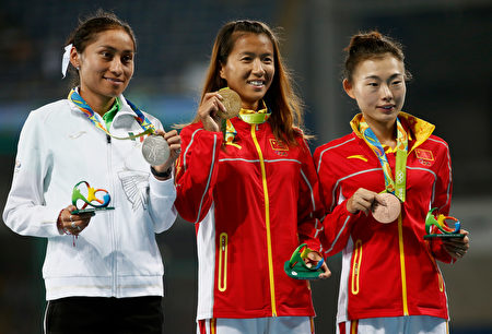RIO DE JANEIRO, BRAZIL - AUGUST 19: (L-R) Silver medalist, Maria Guadalupe Gonzalez of Mexico, gold medalist, Hong Liu of China, and bronze medalist Xiuzhi Lu of China, pose on the podium during the medal ceremony for the Women's 20km Race walk on Day 14 of the Rio 2016 Olympic Games at the Olympic Stadium on August 19, 2016 in Rio de Janeiro, Brazil. (Photo by Phil Walter/Getty Images)