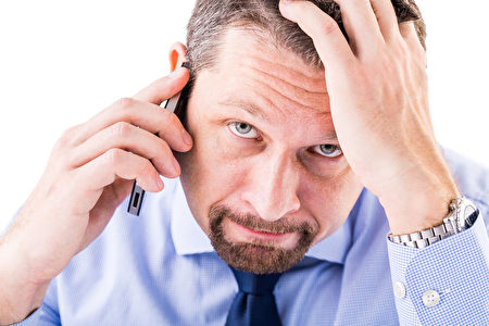 Stressed businessman making a phone call.（fotolia）