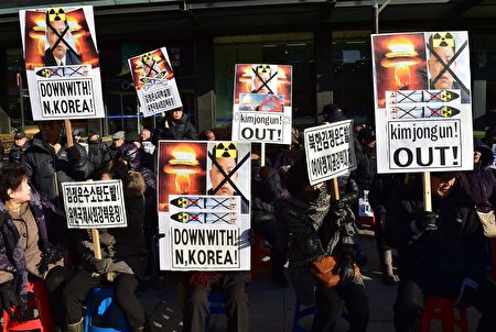 South Korean conservative activists hold placards showing portraits of North Korean leader Kim Jong-Un during a rally denouncing North Korea's hydrogen bomb test, in Seoul on January 7, 2016. The US and South Korean presidents vowed on January 7 to impose the "most powerful and comprehensive" sanctions on North Korea after its globally condemned fourth nuclear test. AFP PHOTO / JUNG YEON-JE / AFP / JUNG YEON-JE (Photo credit should read JUNG YEON-JE/AFP/Getty Images)