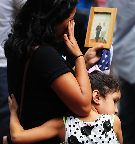 NEW YORK, NY - SEPTEMBER 11: A young girl holds her mother during a commemoration ceremony for the victims of the September 11 terrorist attacks at the National September 11 Memorial and Museum fifteen years after the day on September 11, 2016 in New York City. Throughout the country services are being held to remember the 2,977 people who were killed in New York, the Pentagon and in a field in rural Pennsylvania. (Photo by Spencer Platt/Getty Images)