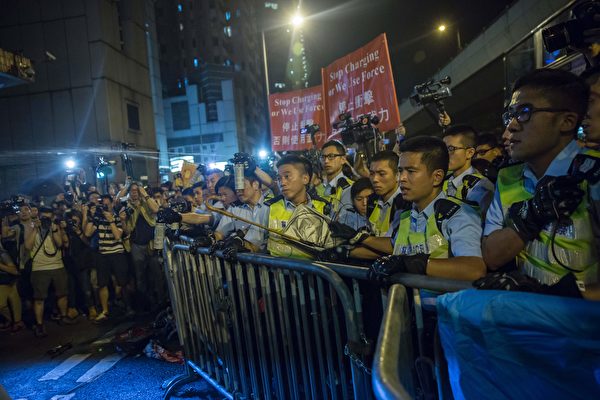 Police use pepper spray to stop protesters charging outside the Chinese Liason Office in Hong Kong on November 6, 2016, during a protest against an expected interpretation of the city's constitution -- the Basic Law -- by China's National People's Congress Standing Committee (NPCSC) over the invalid oath-taking attempts by newly elected lawmakers Baggio Leung and Yau Wai-ching at the Legislative Council last month. Thousands took to Hong Kong's streets on November 6 after Beijing said it would step into an escalating row over whether two city lawmakers who advocate a split from China should be banned from taking up their seats. / AFP / ISAAC LAWRENCE (Photo credit should read ISAAC LAWRENCE/AFP/Getty Images)