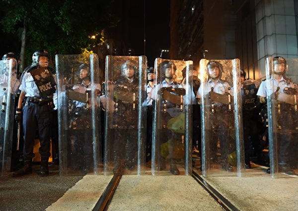 Police stand guard during a stand-off with demonstrators amid ongoing protests in Hong Kong on November 6, 2016. Hong Kong police used pepper spray November 6 to drive back hundreds of protesters angry at China's decision to intervene in a row over whether two pro-independence lawmakers should be barred from the city's legislature. In chaotic scenes reminiscent of mass pro-democracy protests in 2014, demonstrators charged metal fences set up by police outside China's liaison office in the semi-autonomous city. / AFP / Anthony WALLACE (Photo credit should read ANTHONY WALLACE/AFP/Getty Images)