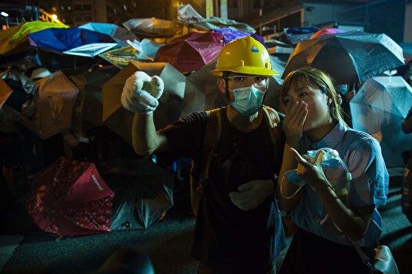 Yau Wai-ching (R) of the Youngspirations organisation speaks with a protester (L) amid ongoing demonstrations in Hong Kong on November 6, 2016. Hong Kong police used pepper spray November 6 to drive back hundreds of protesters angry at China's decision to intervene in a row over whether two pro-independence lawmakers should be barred from the city's legislature. In chaotic scenes reminiscent of mass pro-democracy protests in 2014, demonstrators charged metal fences set up by police outside China's liaison office in the semi-autonomous city. / AFP / ISAAC LAWRENCE (Photo credit should read ISAAC LAWRENCE/AFP/Getty Images)