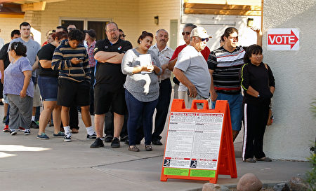 PHOENIX, AZ - NOVEMBER 08: Voters wait in line at the Maryvale Church of the Nazarene polling place to cast their vote on November 8, 2016 in Phoenix, Arizona. Americans across the nation are picking their choice for the next president of the United States. (Photo by Ralph Freso/Getty Images)