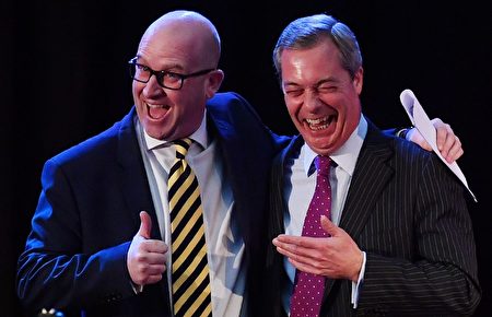 Former UK Independence Party (UKIP) leader, Nigel Farage, (R) reacts as he poses with newly-elected leader of the UK Independence Party (UKIP), Paul Nuttall, following the leadership announcement in central London on November 28, 2016. Britain's anti-EU party UKIP elected former history lecturer Paul Nuttall as its new leader to take over from Brexit firebrand Nigel Farage, a political ally of US President-elect Donald Trump. / AFP / BEN STANSALL (Photo credit should read BEN STANSALL/AFP/Getty Images)