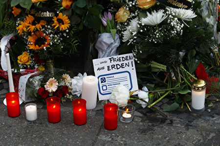 BERLIN, GERMANY - DECEMBER 20: A message reading freedom on Earth lays between flowers at the area after a lorry truck ploughed through a Christmas market on December 20, 2016 in Berlin, Germany. So far 12 people are confirmed dead and 45 injured. Authorities have confirmed they believe the incident was an attack and have arrested a Pakistani man who they believe was the driver of the truck and who had fled immediately after the attack. Among the dead are a Polish man who was found on the passenger seat of the truck. Police are investigating the possibility that the truck, which belongs to a Polish trucking company, was stolen yesterday morning. (Photo by Michele Tantussi/Getty Images)