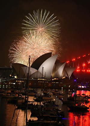 A family fireworks illuminates the sky above the iconic Opera House in Sydney on December 31, 2016, ahead of New Years fireworks. / AFP / SAEED KHAN (Photo credit should read SAEED KHAN/AFP/Getty Images)