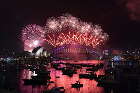 New Year fireworks illuminate the sky over the iconic Opera House and Harbour Bridge in Sydney on January 1, 2017. / AFP / SAEED KHAN (Photo credit should read SAEED KHAN/AFP/Getty Images)