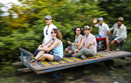BATTAMBANG - DECEMBER 20: Tourists are riding the old fashioned bamboo train at Battambang on December 20, 2012, Cambodia. (Photo by EyesWideOpen/Getty Images)