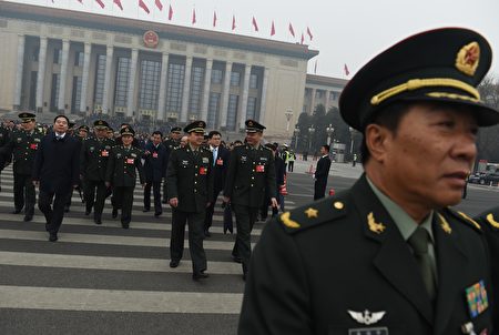 Military delegates walk away from the Great Hall of the People as they leave after a session of the Chinese People's Political Consultative Conference (CPPCC) in Beijing on March 4, 2016. China will raise its defence spending by seven to eight percent this year, a top official said on March 4, following years of double-digit increases as Beijing asserts its territorial claims in the South China Sea. AFP PHOTO / GREG BAKER / AFP / GREG BAKER (Photo credit should read GREG BAKER/AFP/Getty Images)