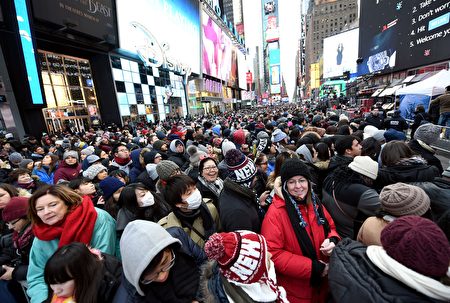 People gather in Times Square to celebrate New Year's Eve in New York on December 31, 2016. / AFP / ANGELA WEISS (Photo credit should read ANGELA WEISS/AFP/Getty Images)